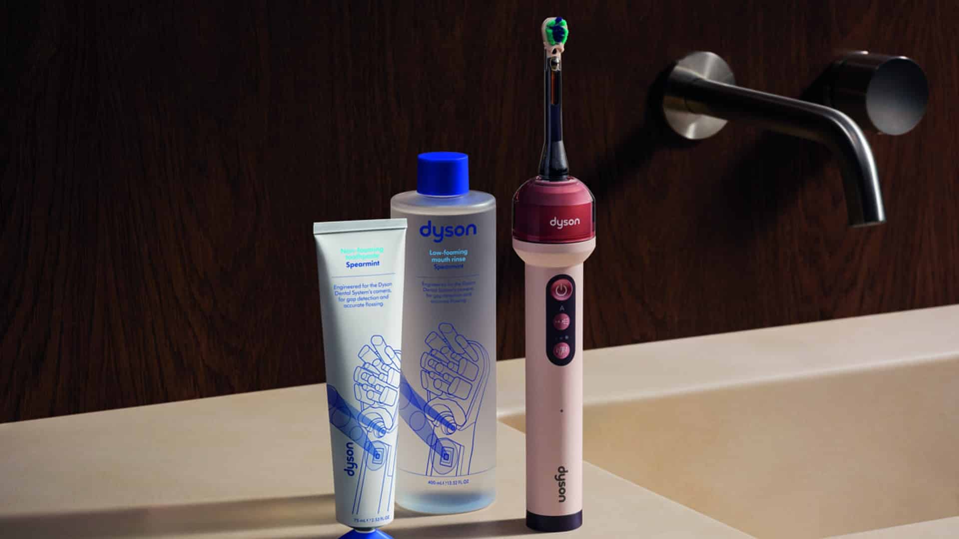 Brosse à dents Dyson CameraJet et système dentaire Dyson (dentifrice et bain de bouche) posés sur un lavabo